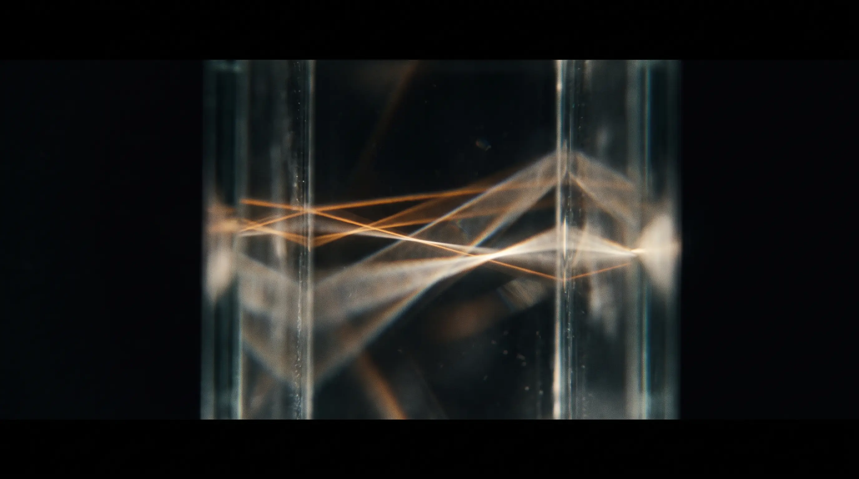 Amber light refracting through stacked glass panes